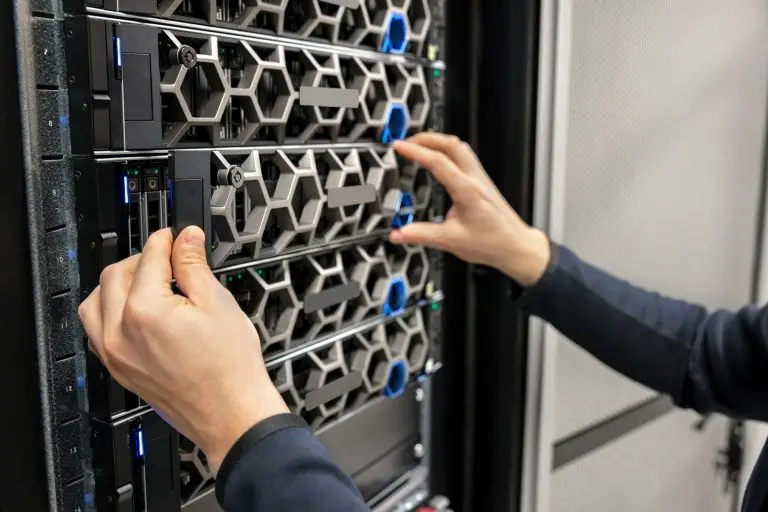 Trusted managed IT support services to protect and power your business 1 Hands of male Managed IT support services company adjusting hardware.