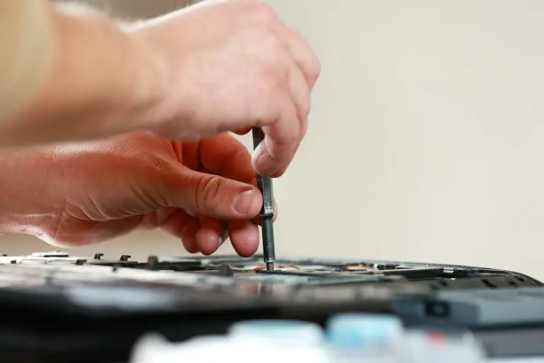 Trusted managed IT support services to protect and power your business 3 Repaiman with screwdriver fixing disassembled laptop parts. Technical support and fixing gadgets pro